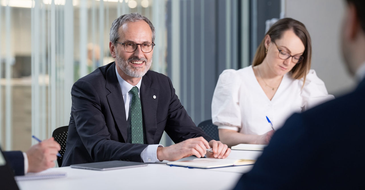 Christophe Jaubert smiling during meeting with fellow Mediolanum employees